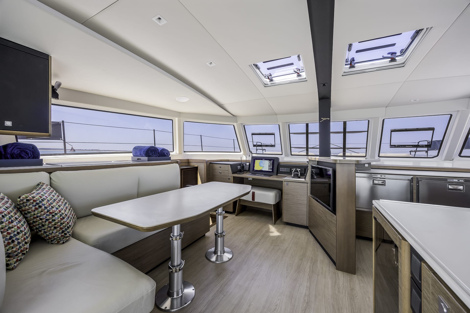Open-plan interior living space aboard the Seven Days luxury catamaran, available for private yacht charters from Poole Harbour.