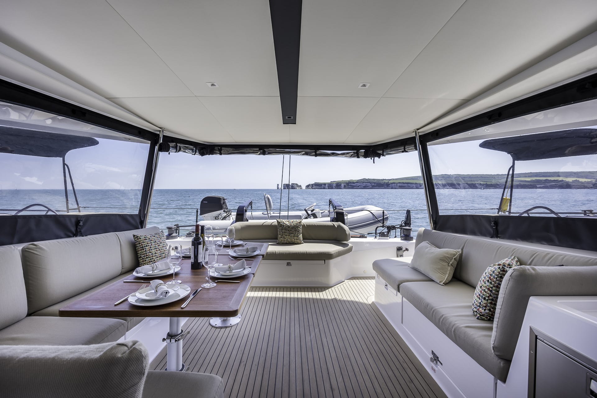 Outdoor dining area aboard the Seven Days luxury catamaran, available for private yacht charters from Poole Harbour along the Dorset Coast.